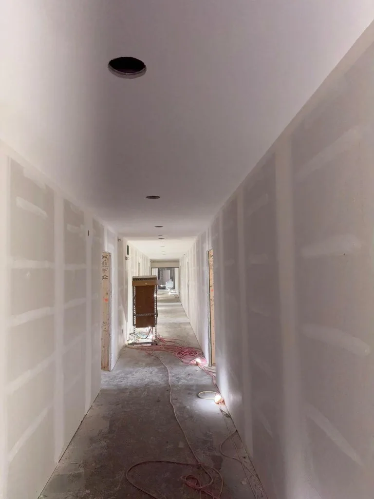 Finished mud work on drywall with ceiling texture and lighting boxes