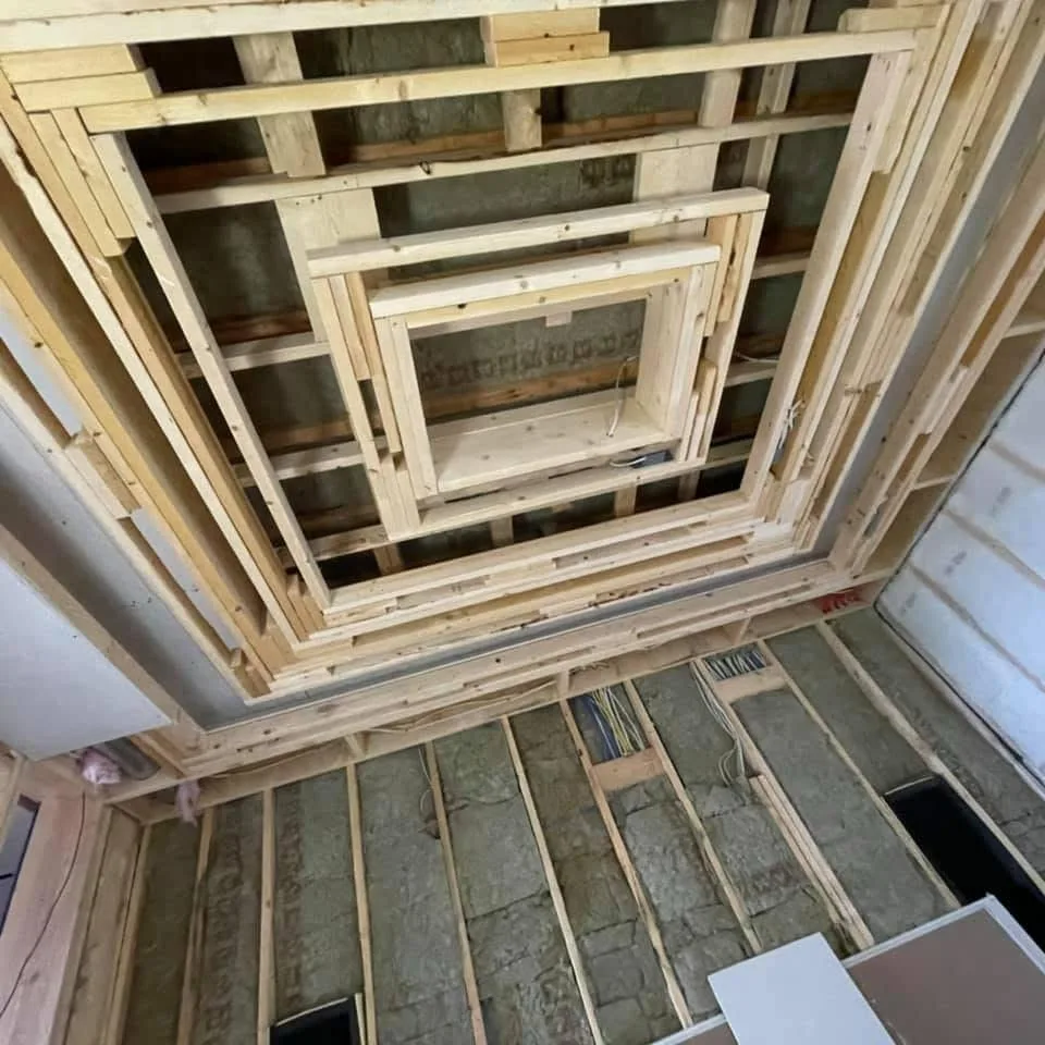 Close view of mudded drywall seams and screw patches